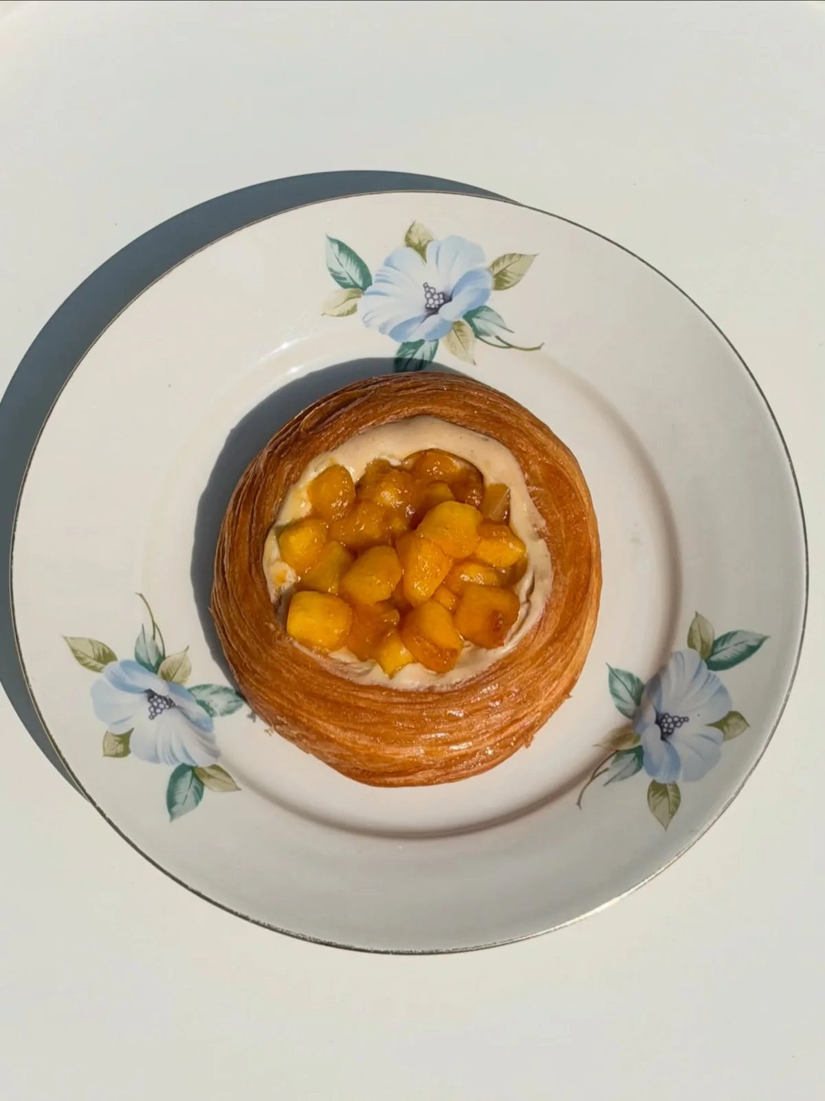 Small fruit tart served on a floral plate