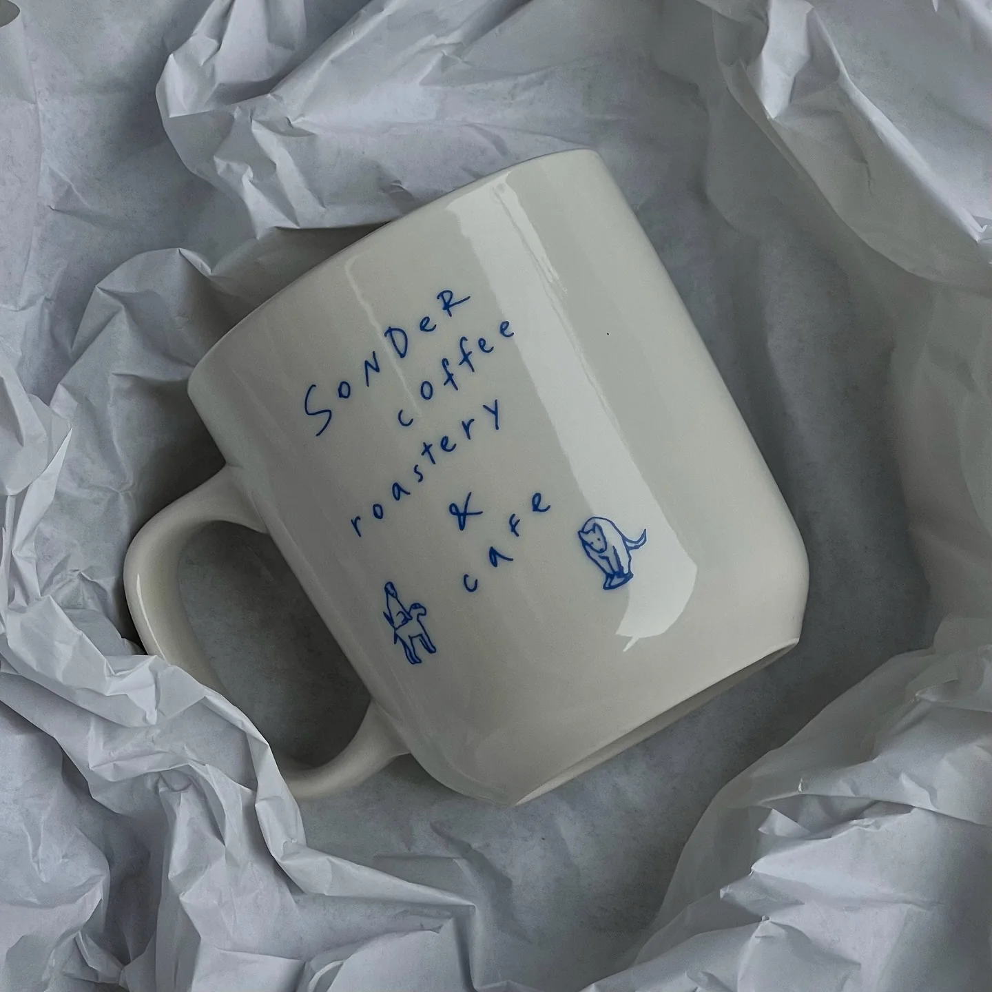 Hand-painted Sonder coffee mug wrapped in paper