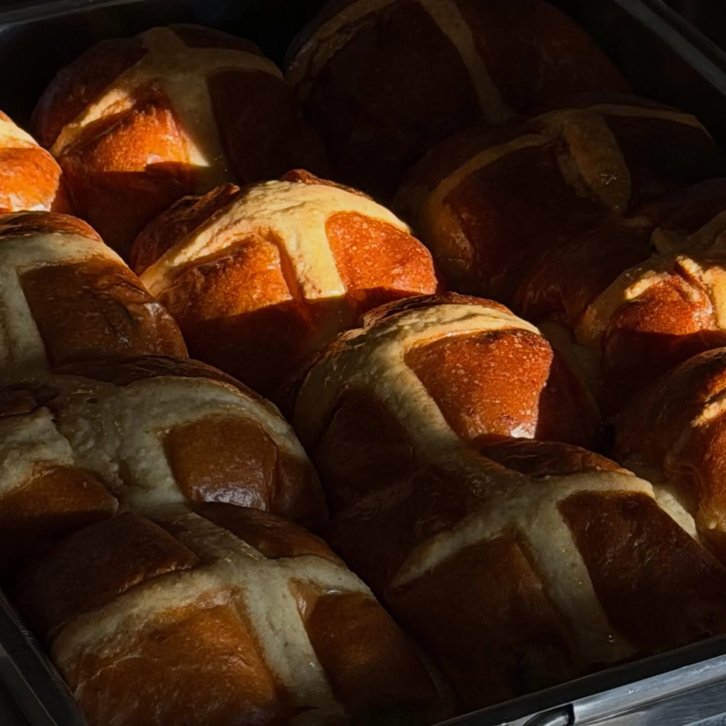 Fresh golden loaves in deep warm light