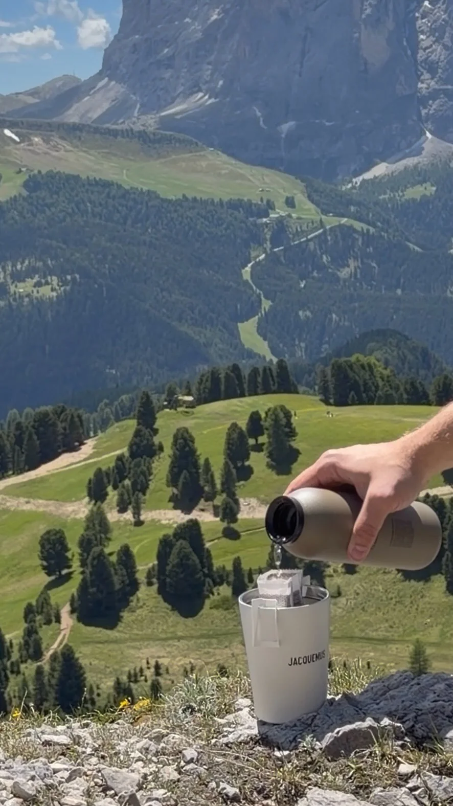 Drip coffee being prepared above a mountain valley
